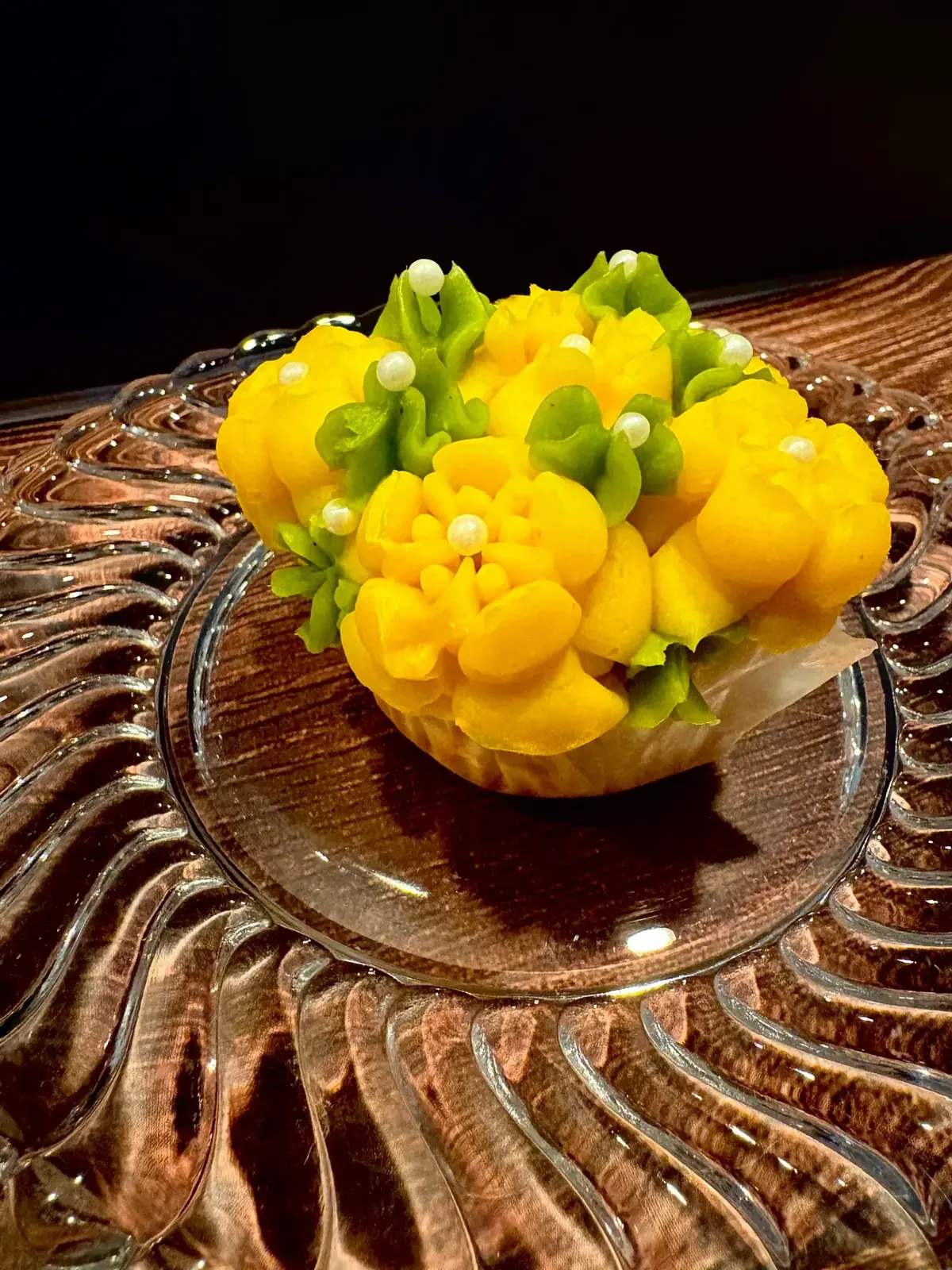 Cupcake piped with yellow buttercream chrysanthemums