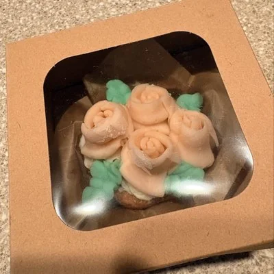 Peach rose cupcakes in a windowed bakery box